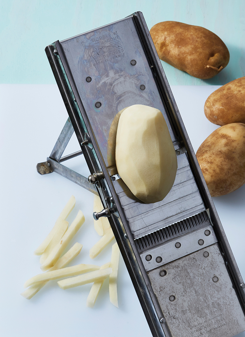 Potato in a vegetable slicer